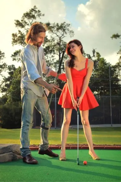 couple playing golf in neverfail dating